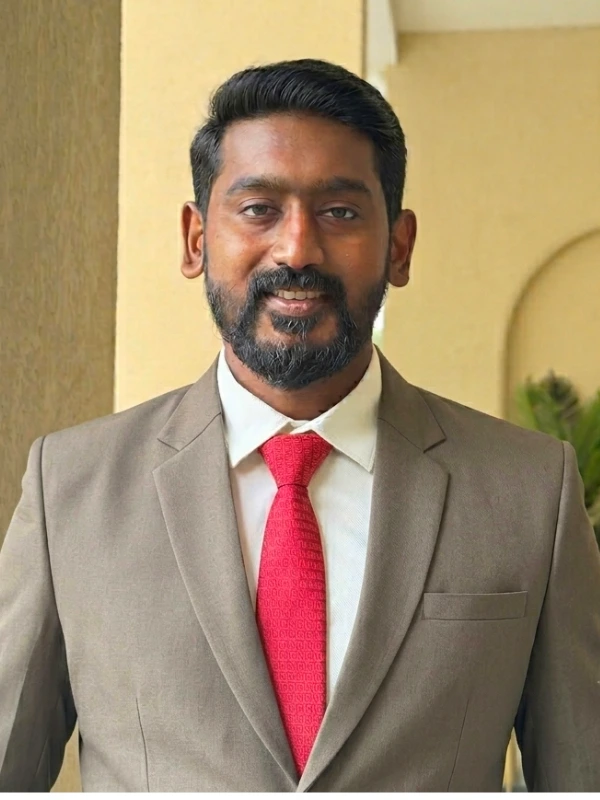 A professional portrait of Dr. Krishnajith, Orthodontist.