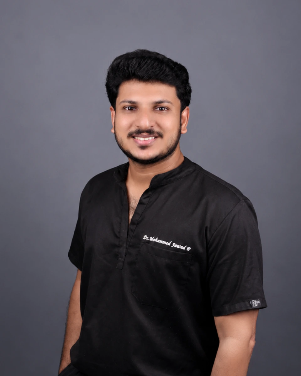 Dentist at Lumiere Dental Clinic in Kondotty holding a digital scanning device for advanced dental care.